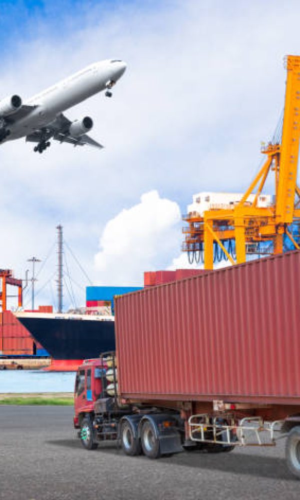 Truck transport container and cago plane flying above ship port with working crane loading bridge in shipyard for logistic import export conceptTruck transport container and cago plane flying above ship port with working crane loading bridge in shipyard for logistic import export concept